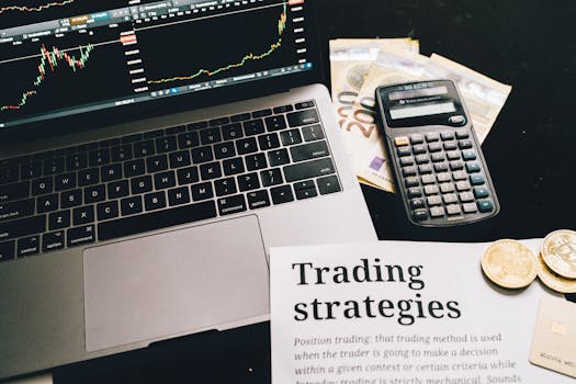 Close-up image of a trading setup with a laptop, calculator, and financial documents, ideal for finance and stock market themes.